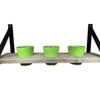 Kruidenrek met groene potjes.