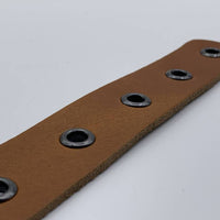 Cognac riem vol met zwarte ringen